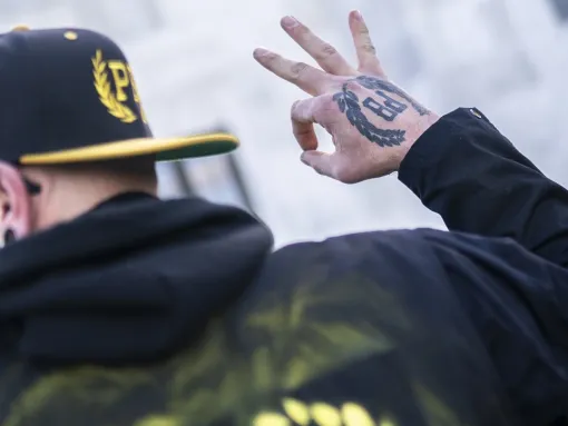 A member of the Proud Boys gestures in front of the Oregon state capitol during a protest in support of the January 6 attack on the U.S. Capitol, on January 8, 2022 in Salem, Oregon.